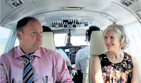  ?? PHOTOS BY ALLAN BENNER/STANDARD STAFF ?? Niagara-on-the-Lake Lord Mayor Pat Darte and Niagara District Airport Commission vice-chair Robin Garrett are pictured aboard a FlyGTA plane preparing for landing at the Niagara-on-the-Lake airport on Tuesday.