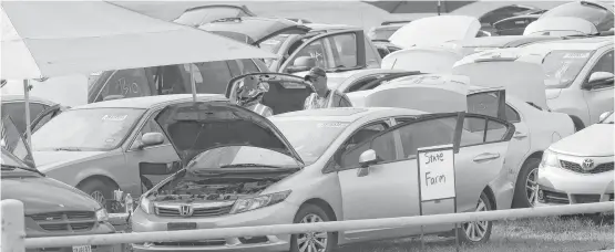  ?? Steve Gonzales / Houston Chronicle ?? Thousands of flooded cars are now at the parking lot of the Royal Purple Raceway in Baytown waiting for adjusters to look them over Sunday.