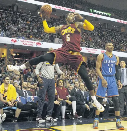  ??  ?? The Cavaliers’ JR Smith saves the ball from going out of bounds against the Thunder.