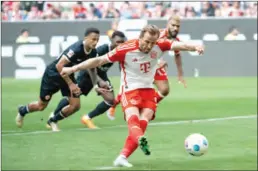  ?? (DPA) ?? Munich’s Harry Kane scores his side’s second goal from the penalty spot during the German Bundesliga match against Eintracht Frankfurt at the Allianz Arena on Saturday.