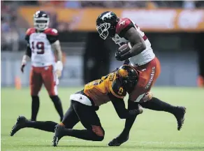  ?? THE CANADIAN PRESS ?? Jerome Messam left the game after taking this hit from B.C.’s Loucheiz Purifoy in last Friday’s contest, but he’ll be in the lineup on Saturday against the Argos.