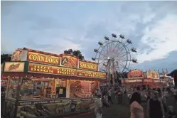  ??  ?? The St. Brendan Festival in Hilliard, back in action after being canceled in 2020 because of the COVID-19 pandemic, is in full swing as twilight descends on Aug. 13.