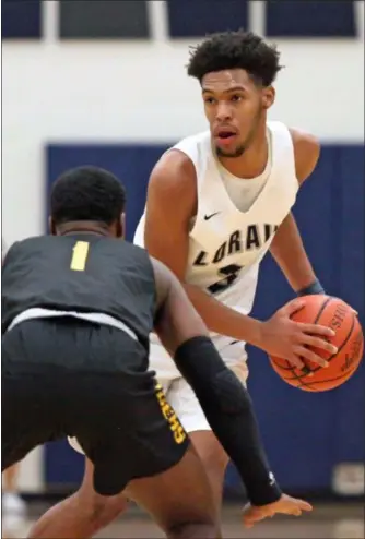  ?? RANDY MEYERS — FOR THE MORNING JOURNAL ?? Devon Grant of Lorain looks over Robert Morgan of Cleveland Heights on Feb. 8.