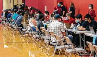  ?? William Luther / Staff photograph­er ?? People register at Southside High School for their COVID-19 vaccine on April 11 during a University of the Incarnate Word and Southside ISD vaccinatio­n clinic.