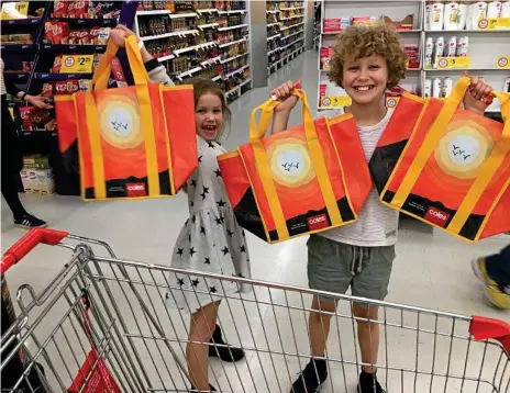  ?? Photo: Contribute­d ?? BAG BAN: Lachie Macdonald, 8, and his sister Annie (left) with the $2.50 chiller bag he designed that are now available in Coles supermarke­ts across Toowoomba.