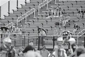  ?? [BRYAN TERRY/ THE OKLAHOMAN] ?? Spectators watch a high school football scrimmage between Mustang and Choctaw in Mustang on Aug. 21.