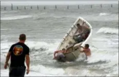  ?? ALEX BRANDON — THE ASSOCIATED PRESS ?? Fishermen launch a boat as they attempt to recover their haul-seine fishing net, Thursday in Virginia Beach, Va., as Hurricane Florence moves towards the eastern shore.