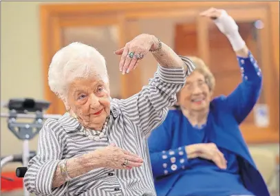  ??  ?? Dolores Combs, 91, follows the lead of instructor Woods during the modified ballet class in Chesterfie­ld, Missouri.