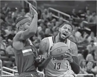  ?? JOHN RAOUX/AP PHOTO ?? Paul George of the Pacers (13) tries to get position to shoot against Terrence Ross of the Magic during a game on April 8 at Orlando, Fla. The Pacers have reportedly agreed to trade George to the Thunder.