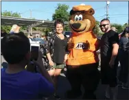  ?? BEA AHBECK/NEWS-SENTINEL ?? Chrissy Orosco and Nicholas Carranco have their picture taken with the A&W Bear as A&W Root Beer celebrates the restaurant’s 100th birthday in Lodi on Friday.