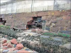  ?? Photo by Jim Arnold ?? Two sections of the defensive wall were damaged during an April storm.