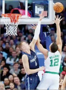  ?? — AFP photo ?? Kristaps Porzingis #6 of the Dallas Mavericks blocks a shot against Grant Williams #12 of the Boston Celtics in the first half at American Airlines Center in Dallas, Texas.