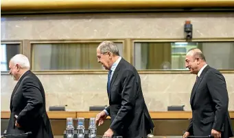  ?? AP ?? Iranian Foreign Minister Mohammad Javad Zarif, left, Russian Foreign Minister Sergei Lavrov and Turkish Foreign Minister Mevlut Cavusoglu leave the room after a joint statement following the consultati­ons on Syria, at the European headquarte­rs of the United Nations in Geneva.