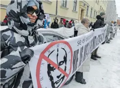  ?? | EPA ?? PROTESTERS hold a banner with a crossed-out picture of Russian President Vladimir Putin, as Russians living in Finland gathered to vote at the Russian embassy in Helsinki, yesterday. Opponents of Putin were called to vote yesterday at noon, on the last day of the Russian presidenti­al election.