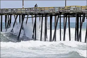 ?? AP/GERRY BROOME ?? Early harbingers of Hurricane Florence, waves crash around a pier Wednesday in Kill Devil Hills, N.C. Residents were keeping a close eye on the storm as it took a southerly turn.