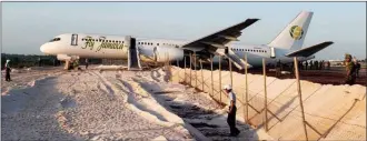  ?? The Associated Press ?? A Fly Jamaica Boeing 757-200 aircraft, which overshot the runway, sits at the northeaste­rn takeoff end of the runway at the Cheddi Jagan Internatio­nal Airport in Georgetown, Guyana, Friday. An airline spokesman said the plane, which was on its way to Toronto, reported a hydraulic failure emergency shortly after taking off and returned after less than 20 minutes. Several people were injured.