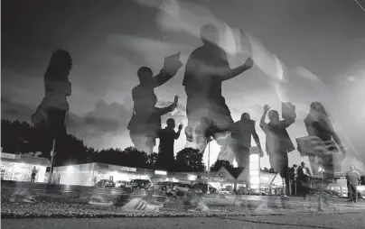  ?? JEFF ROBERSON/AP2014 ?? The Kansas City Star newspaper apologized Sunday for past decades of racially biased coverage. Above, in a photo taken with a long exposure, protesters march in the street as lightning flashes in the distance in Ferguson, Missouri.