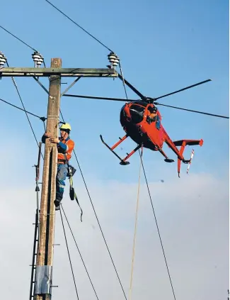  ?? Photo: FAIRFAX NZ ?? Linesmen install fibre-optic cable for the Rural Broadband Initiative on the West Coast.
