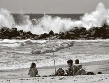  ?? Mark J. Terrill / Associated Press ?? Los Angeles County reopened its beaches, including Venice Beach in Los Angeles, Wednesday in the latest cautious easing of coronaviru­s restrictio­ns that have closed most California public spaces and businesses for nearly two months.