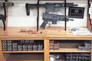  ?? PHOTOS BY JOSHUA A. BICKEL/COLUMBUS DISPATCH ?? Ar-style pistols, left, and Ar-style rifles sit on display at L.E.P.D. Firearms, Range and Training Facility.