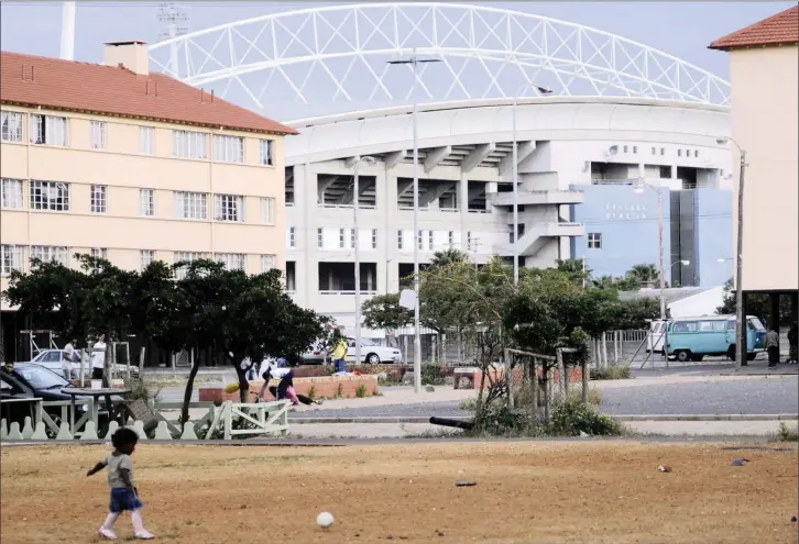  ??  ?? Kewtown in Athlone with Athlone Stadium as a backdrop. The stadium is a multi-use venue and regularly hosts competitio­ns in the lead-up to the annual Kaapse Klopse New Year minstrel competitio­n. PICTURE: MATTHEW JORDAAN