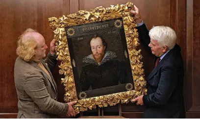  ?? Kirsty O’Connor ?? Conservato­r Adrian Phippen (left) and Art and Antiques writer Duncan Phillipps with a portrait of William Shakespear­e, by artist Robert Peake. Believed to be the only signed and dated image of the playwright created during his lifetime, it is on display at the Grosvenor House Hotel, London, before going up for sale by private treaty, for a figure in excess of £10 million.