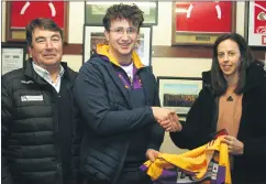  ?? ?? Goalkeeper, Eoin Davis, receiving his medals and All-Ireland jersey, with Thomas O’Donnell and Orla Cotter in attendance, at a recent function at our clubrooms.