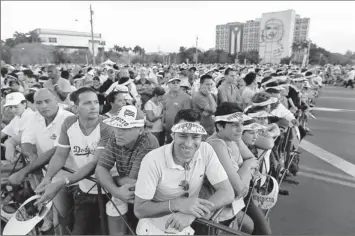  ?? Photos by Joe Raedle, Getty Images ?? Anticipati­on:
People wait for the arrival of Pope Benedict XVI for his Mass at Havana’s Plaza of the Revolution on Wednesday, the last day of his three-day visit to Cuba. It was Benedict’s first trip to the communist country.