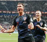  ?? Frank Augstein / Associated Press ?? Mario Mandzukic, center, put Croatia ahead of England with his country’s second goal of the match.