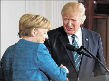  ?? ANDREW HARNIK / ASSOCIATED PRESS ?? President Donald Trump and German Chancellor Angela Merkel shake hands following a joint news conference in the East Room of the White House in Washington on Friday.