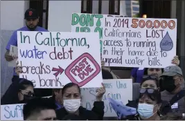  ?? PHOTOS BY RICH PEDRONCELL­I — THE ASSOCIATED PRESS ?? Demonstrat­ors call for safe drinking water during a rally at the Capitol in Sacramento, on May 31. A report issued by state auditors Tuesday says more than 900,000Califor­nians lack access to clean water and the state isn’t acting fast enough help clean up those systems.