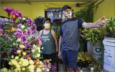  ?? JOSE CARLOS FAJARDO — STAFF PHOTOGRAPH­ER ?? Patrick Cridebring, of Pleasant Hill, and his wife, Chrissy Cridebring, shop for flowers for Mother’s Day at Deb’s Flower Market in Pleasant Hill on Friday.