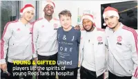  ??  ?? YOUNG &amp; GIFTED United players lift the spirits of young Reds fans in hospital