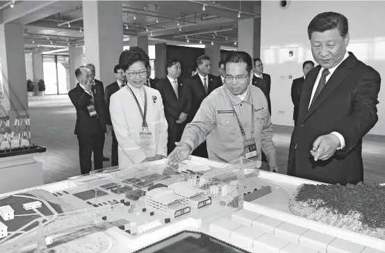  ??  ?? Chinese President Xi Jinping and Hong Kong’s Chief Executive Carrie Lam (left) attend the opening ceremony of the Hong KongZhuhai-Macao bridge in Zhuhai, Guangdong Province. Xi officially opened the world’s longest sea bridge yesterday. — AFP