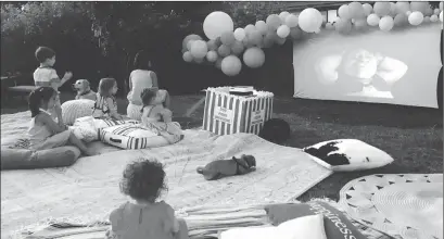  ?? Associated Press photo ?? This photo provided by Wittybash.com shows children at a backyard birthday party watching the movie "Shrek" on an outdoor theater setup in Concord, Calif.