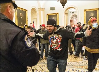  ?? MANUEL BALCE CENETA — THE ASSOCIATED PRESS ?? Supporters of President Donald Trump are confronted by Capitol Police officers outside the Senate Chamber at the Capitol, Wednesday, Jan. 6, 2021 in Washington.