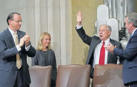  ?? AP ?? GOODBYE: Attorney General Jeff Sessions, right, shown waving at an awards ceremony last week, resigned Wednesday. At far left is Deputy Attorney General Rod Rosenstein.