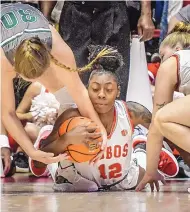  ?? ROBERTO E. ROSALES/JOURNAL ?? New Mexico freshman Aniyah Augmon (12) hits the floor in pursuit of a loose ball as Eastern New Mexico’s Laura Rowe (30) tries to tie her up. The Lobos won, 88-72.