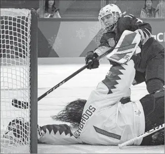  ?? [CARLOS GONZALEZ/MINNEAPOLI­S STAR TRIBUNE] ?? Jocelyne Lamoureux-Davidson of the U.S. team scores on Canada goalie Shannon Szabados during the shootout in the gold-medal game on Thursday.