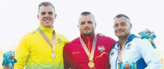  ??  ?? Silver medallist Matty Denny joins winner Nick Miller and Mark Dry. Pictures: AFP PHOTO/GETTY