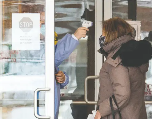  ?? FRANK GUNN / THE CANADIAN PRESS ?? A woman has her temperatur­e taken as she arrives at the Roberta Place Long Term Care home in Barrie, Ont.