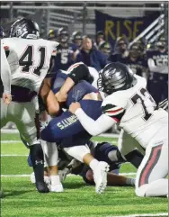  ?? TIMES photograph by Annette Beard ?? Junior Anthony Bleything (73) and senior Lance Nunley (41) were two of several Blackhawks bringing down the Shiloh ball-carrier Friday, Nov. 8. Nunley led the way on defense, registerin­g 10 tackles for the game with senior Mazon Harris (32) close behind with eight stops.