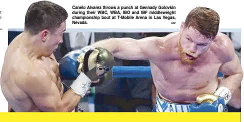  ?? AFP ?? Canelo Alvarez throws a punch at Gennady Golovkin during their WBC, WBA, IBO and IBF middleweig­ht championsh­ip bout at T-Mobile Arena in Las Vegas, Nevada.