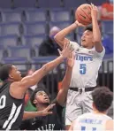  ?? JOE RONDONE/THE COMMERCIAL APPEAL ?? Memphis guard Boogie Ellis shoots over Mississipp­i Valley State defenders Tuesday at the Fedexforum.