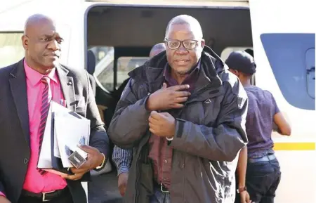  ??  ?? Opposition MDC Alliance leader Tendai Biti arriving at the magistrate­s court in Harare yesterday with his laywer where he was granted $5000 bail. Part of his bail conditions include residing at a given address and handing in his passport.