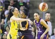  ?? Elaine Thompson / Associated Press ?? Seattle Storm’s Sue Bird, left, passes as Phoenix Mercury’s Briann January (12) and Diana Taurasi (3) defend in the first half of a WNBA playoff semifinal on Aug. 26, 2018, in Seattle. Both Bird, the league’s oldest player at 39, and Taurasi, 38, will be playing when the season starts.