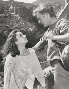  ?? MGM 1965 ?? Elizabeth Taylor and Richard Burton in “The Sandpiper”: A shocked world ogled their devil-may-care real-life romance, but scorned the film.
