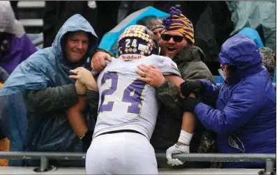  ?? Arkansas Democrat-Gazette/THOMAS METTHE ?? Booneville’s Anthony Mckesson climbs into the stands to celebrate with fans after the Bearcats’ victory over Osceola on Saturday in the Class 3A championsh­ip game at War Memorial Stadium in Little Rock.