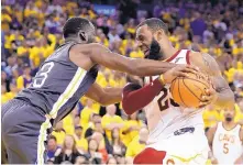  ?? MARCIO JOSE SANCHEZ/ASSOCIATED PRESS ?? Golden State’s Draymond Green, left, defends against Cleveland’s LeBron James. They are friends, but not much during the NBA Finals, as the series shifts to Cleveland on Wednesday.