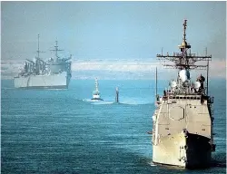  ?? TNS ?? The USS Normandy, front, is pictured transiting the Suez Canal. Sailors from the Normandy boarded a dhow earlier this month and seized anti-tank and surface-to-air missiles they said were bound for Houthi rebels in Yemen.